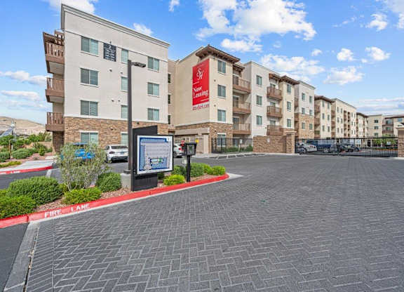 an empty parking lot in front of an apartment building