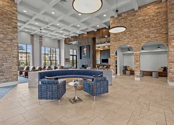 a lobby with couches and chairs and a fireplace