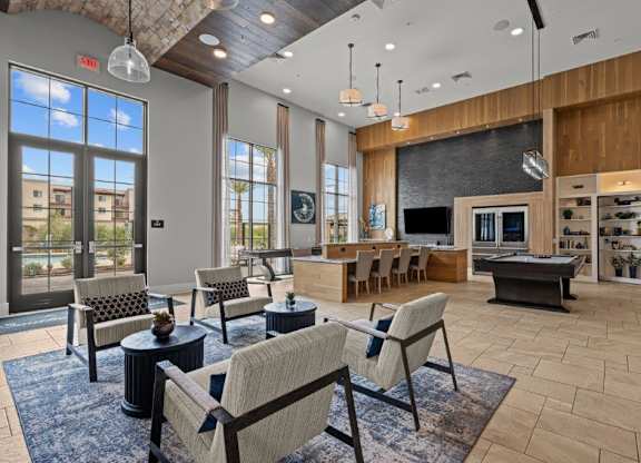 a living room with a fireplace and a table with chairs