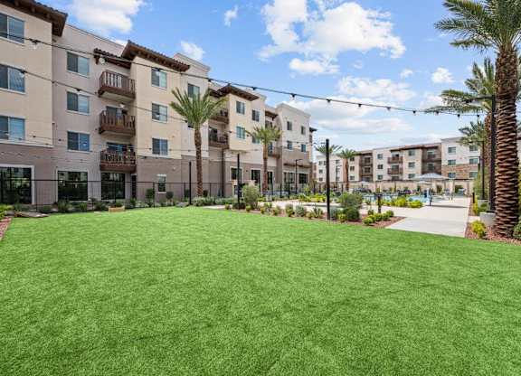 a lush green lawn in front of an apartment building