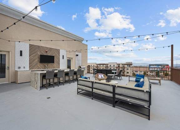 the patio of a building with a table and chairs and a bar