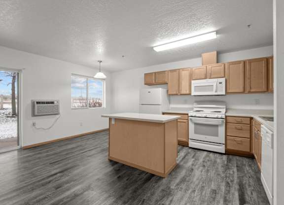 A kitchen with wooden cabinets and a white stove top oven.