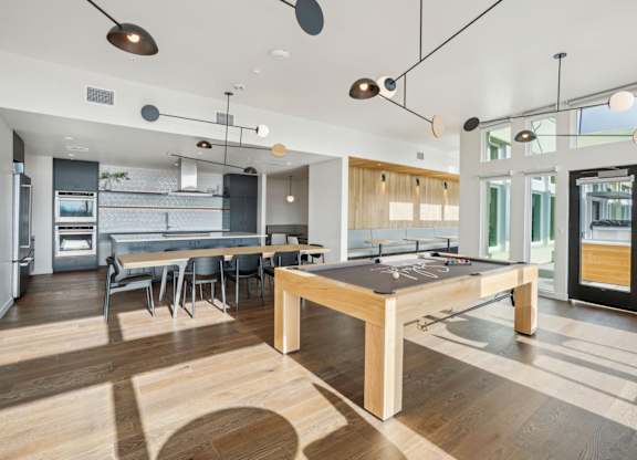 A modern kitchen with a dining table and chairs.