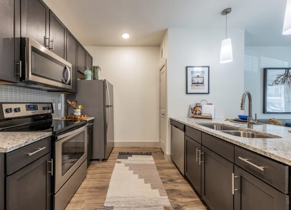 Lenox SoCo Apartments kitchen with stainless steel appliances and granite counter tops