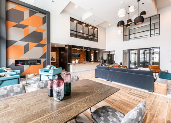 Lenox SoCo Apartments clubhouse living area with couches and tables