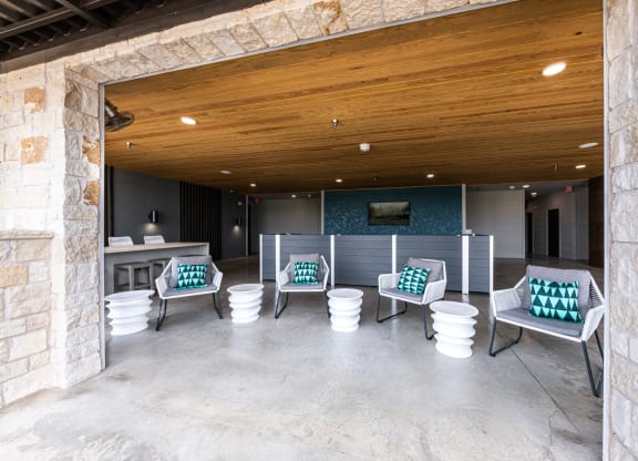 Lenox SoCo Apartments lounge area with chairs and tables and a wooden ceiling