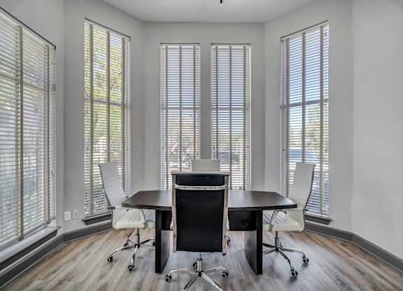 A conference room with a table and chairs.