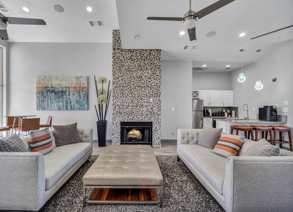 A living room with a fireplace and two couches.