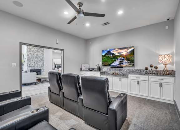 A modern living room with a large couch and a television.