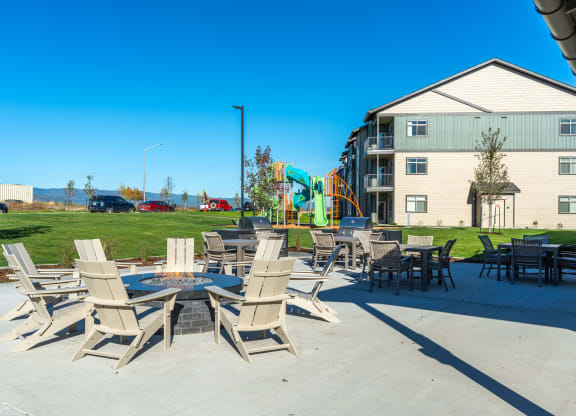 Stillwater Crossing  Apartments Exterior patio with firepit and chairs