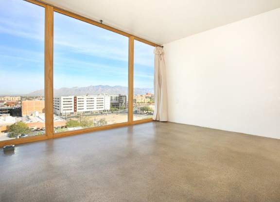A room with a large window overlooking a cityscape at Herbert Residential, Arizona 85701
