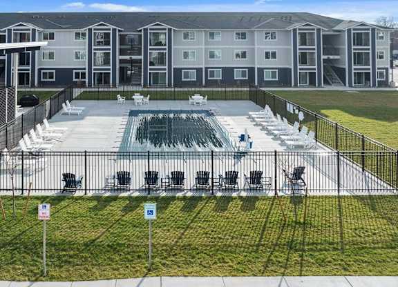 A large building with a pool in front.