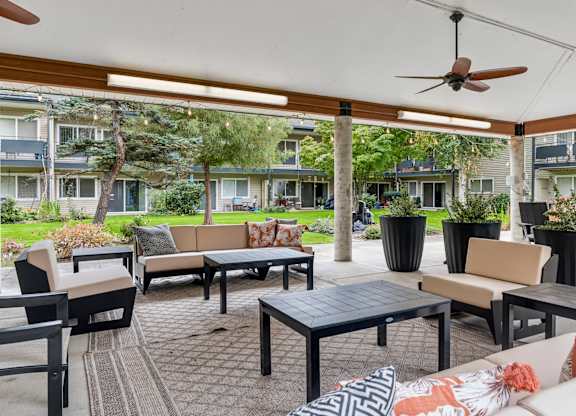 A patio with a table and chairs under a white canopy.