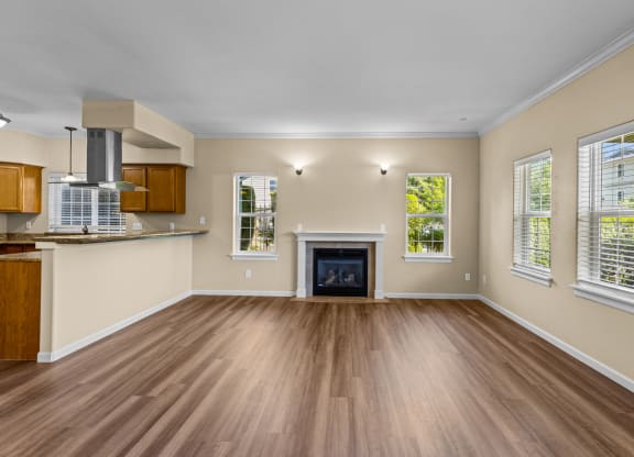 Little Tuscany Apartments & Townhomes - Fireplace in Living Room, Breakfast Bar, Wood Vinyl Plank Flooring - located in Olympia