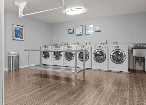 A laundromat with a row of washing machines.