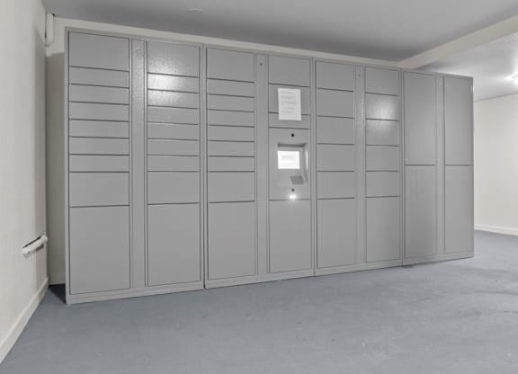 A room with grey cabinets and a white wall.