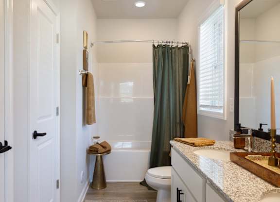 A bathroom with a white toilet, a white sink, and a white door.