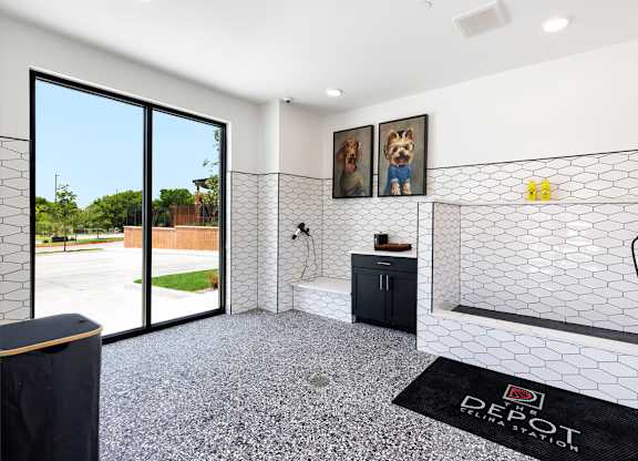 A bathroom with a black mat on the floor that says "DEPOT".