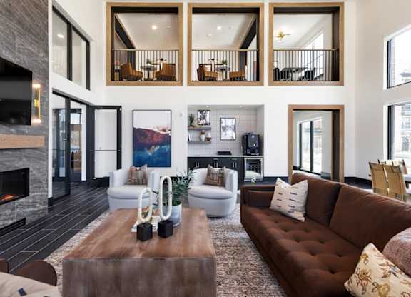A modern living room with a fireplace and a large painting on the wall.