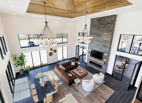 A modern living room with a fireplace and a large window.