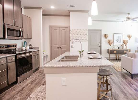 The Flats at Shadowglen Apartments in Manor, TX Model Kitchen with Island
