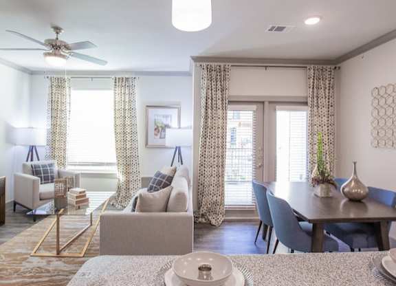 The Flats at Shadowglen Apartments in Manor, TX Model Kitchen and Living Room