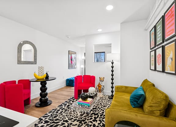 A living room with a leopard print rug and a yellow couch.