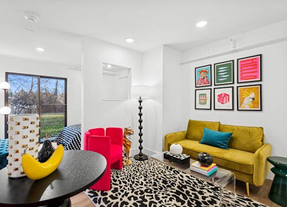 A living room with a leopard print coffee table and a yellow banana sculpture on it.