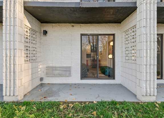 A white building with a black door and windows.