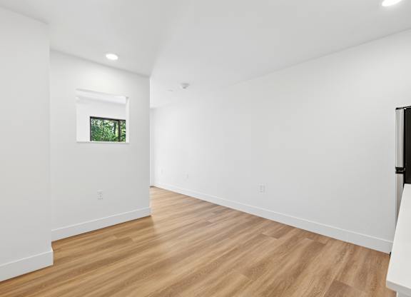 A room with wooden floors and white walls.