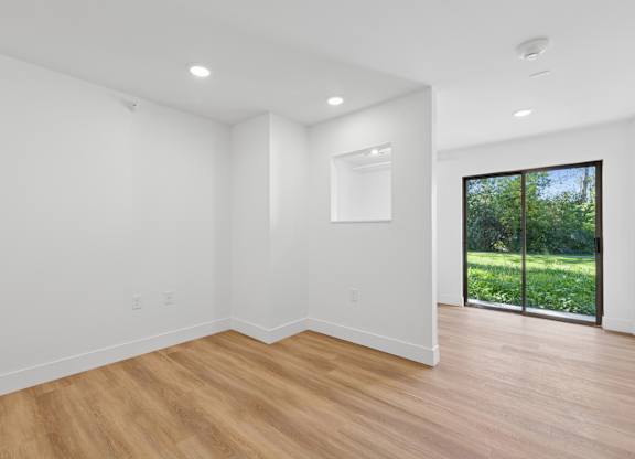 A room with wooden floors and white walls.