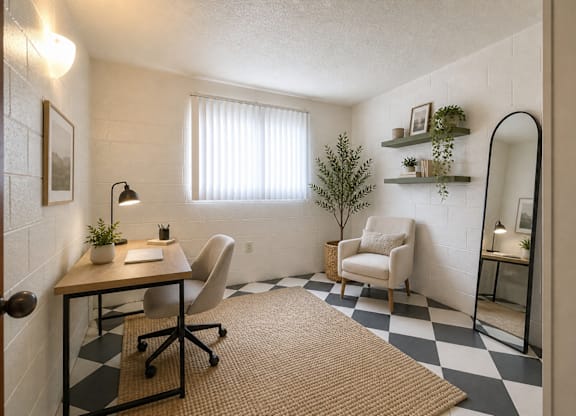 A room with a desk, chair, and mirror.