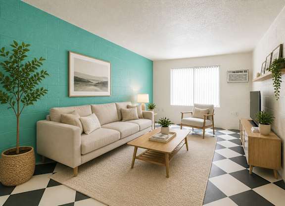 A living room with a couch, chair, and a plant.