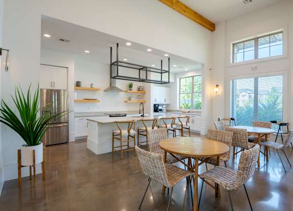A modern kitchen with a dining table and chairs.