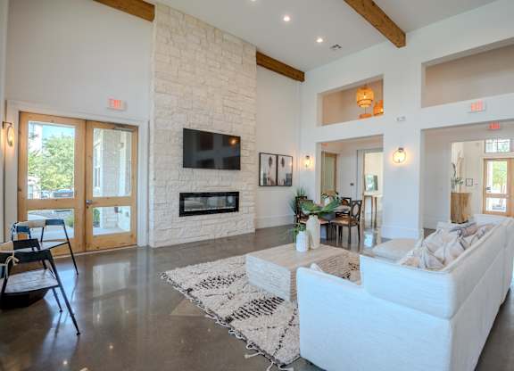 A living room with a fireplace and a white couch.