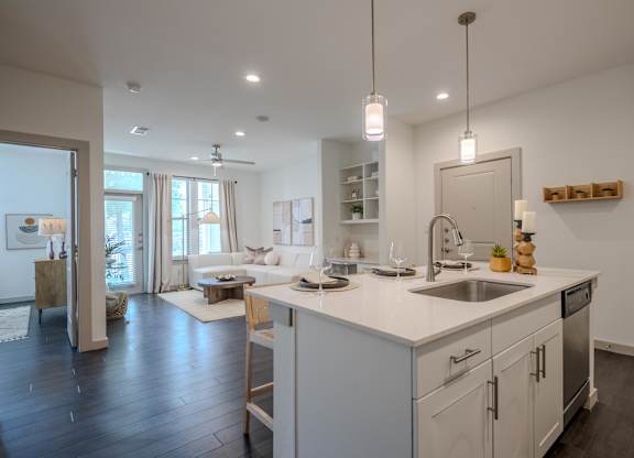 A modern kitchen with a large island and a dining area.