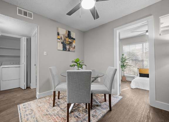 A dining room with a table and chairs.