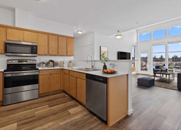 A modern kitchen with wooden cabinets and stainless steel appliances.