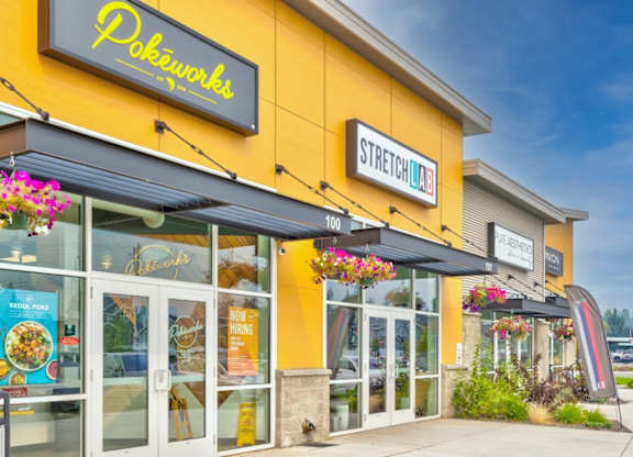 A yellow building with a sign that says "Pokéworks" on it.
