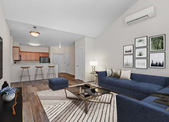 A living room with a blue couch and a coffee table.