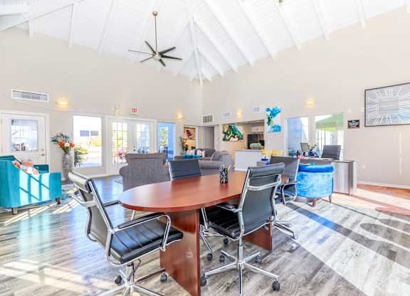 A conference room with a table and chairs.