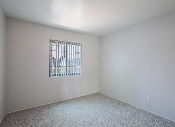 A room with a window and a car outside.