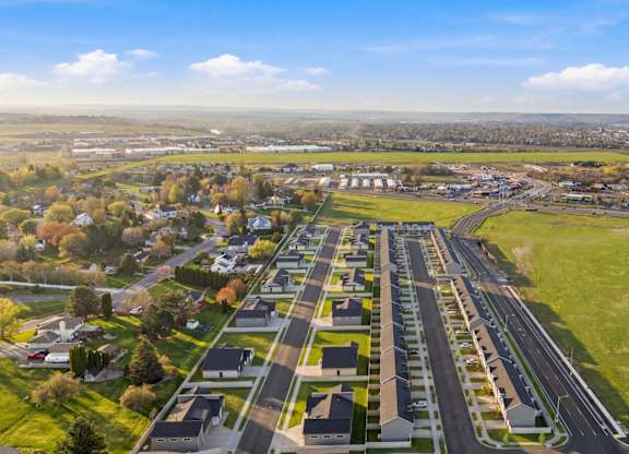 A large aerial view of a suburban area with a complex of buildings and a road network.