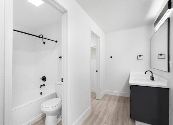 Modern bathroom with white walls and black finishes at The Rosewood Apartments in Vancouver, Washington.