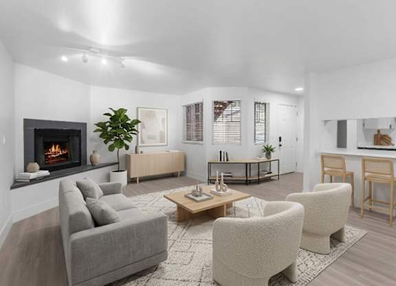 A modern living room with white walls and a fireplace at The Rosewood Apartments in Vancouver, Washington.