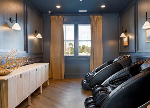 A room with black chairs and a wooden cabinet.