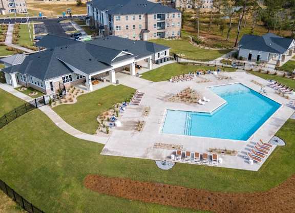 A large building with a pool in front of it.