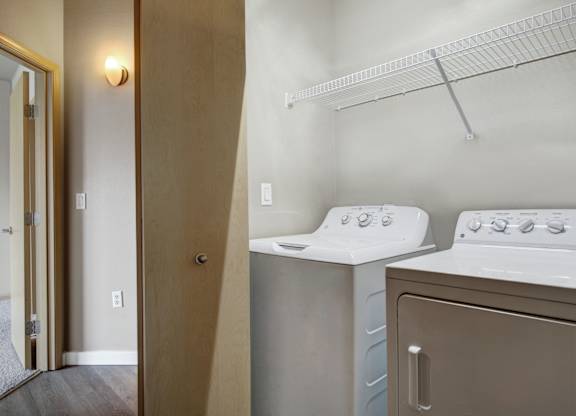 A small laundry room with a washer and dryer.