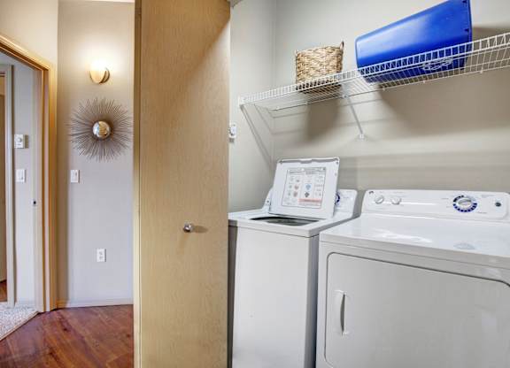 A small laundry room with a washer and dryer.