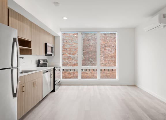The Warren Apartments kitchen and stainless steel appliances and living room